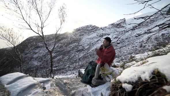 Mature Hiker Resting On Mountain Climb