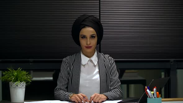 Young Woman Looking at Camera In Office