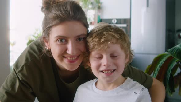 Portrait of Happy Mother with Little Son at Home