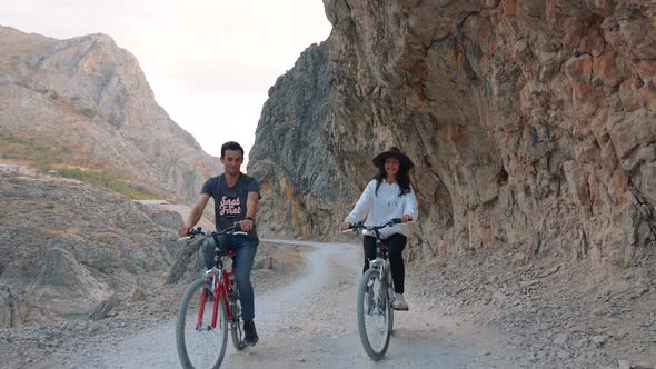 Couple Enjoying Bike Ride in Mountains
