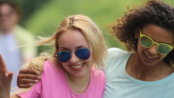 Two Young Pretty Woman Jumping at Concert, Making Dance Moves From Side to Side