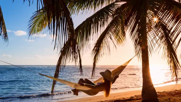 Woman in hammock on beach