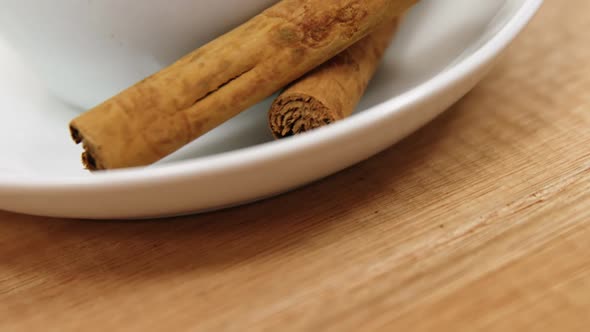 Close-up of coffee cup with cinnamon sticks