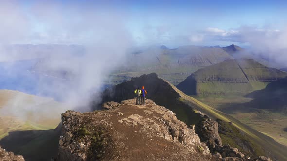 Aerial View of Two People on the Top of Mountain Looking the Beautiful Landscape Sea Cliff Mountain