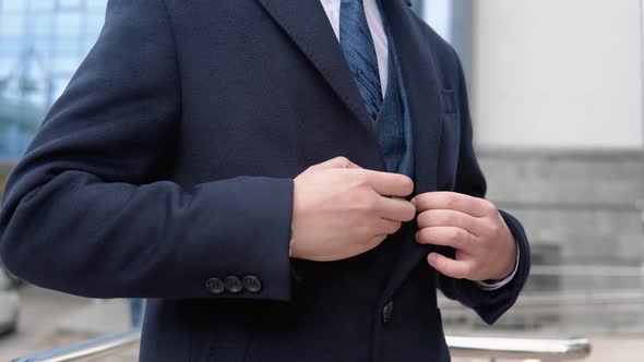 Closeup Man Buttoning His Coat