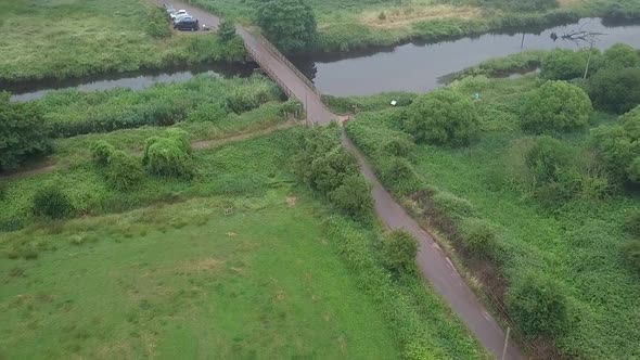 Aerial view of a road and a bridge over the River Otter. Devon, England. DOLLY FORWARD, CROP