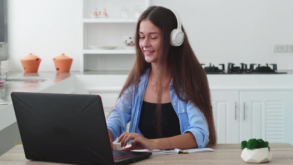 Woman in Headphones Have Chat Using Laptop