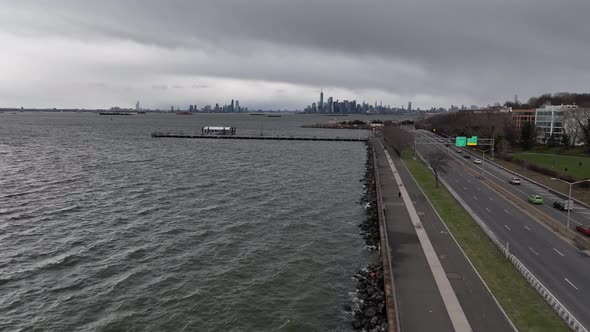 An aerial view over the paved walkway along the Belt Parkway by Upper Bay in Brooklyn NY. The camera