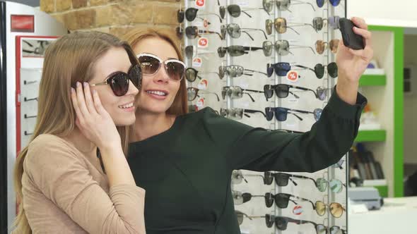 Gorgeous Happy Women Taking Selfies While Shopping Eyewear
