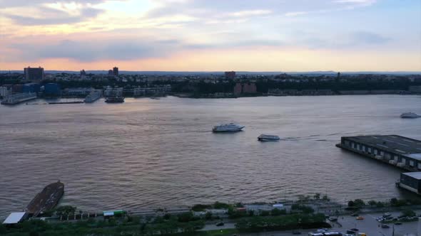 beautiful sunset hyper-lapse at Hudson Yards in New York City, drone camera pan right with New Jerse