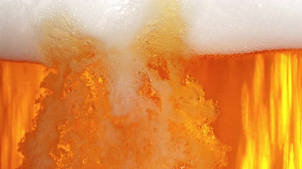 Super Slow Motion Shot of Pouring Fresh Beer Into Glass with Foam at 1000Fps
