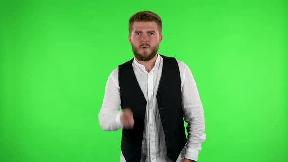 Man Waves His Finger Menacingly and Shows His Fist. Green Screen