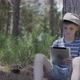 Boy using digital tablet in the woods - VideoHive Item for Sale