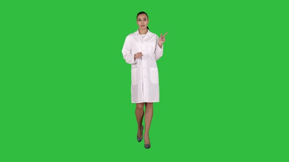 Attractive doctor pointing to the side presenting product