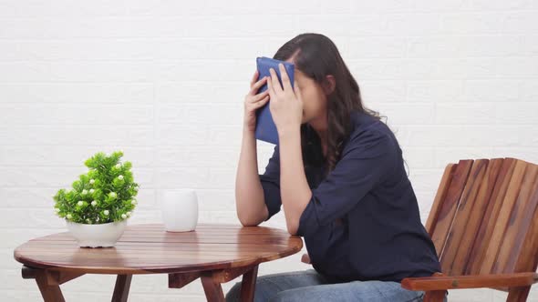 Disappointed Indian girl reading a book