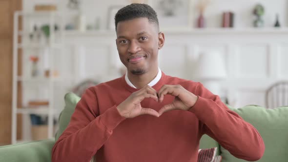 Portrait of African Man showing Heart Shape by Hands