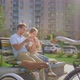 Happy Young Couple Resting After Cycling on a Bench on a Sunny Summer Day - VideoHive Item for Sale