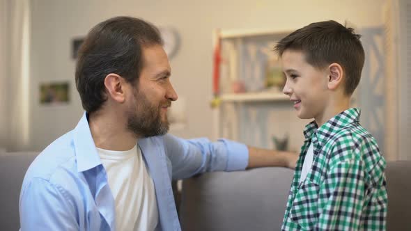 Middle-Aged Father Hugging Schoolboy Son, Family Care and Trustful Relations