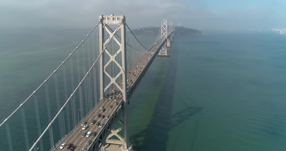 Aerial shot of vehicles moving on San Francisco–Oakland Bay Bridge with city in background