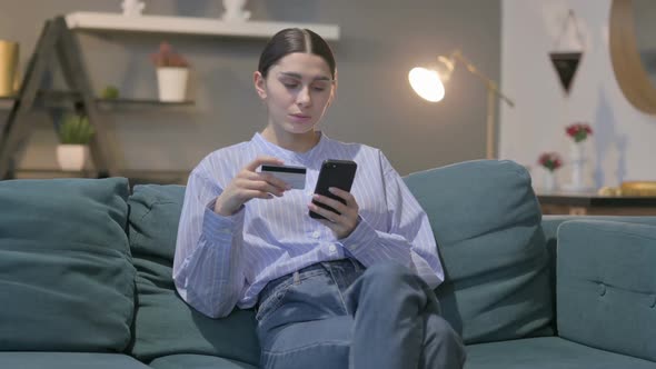 Hispanic Woman making Online Payment on Smartphone