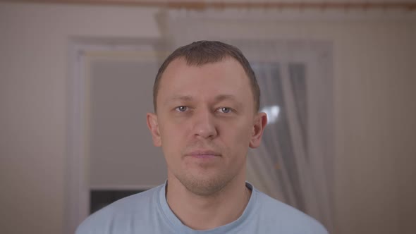 Portrait of a young man standing in a room