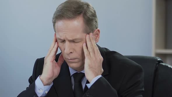 Businessman Suffers From Sick Headache, Problem at Work, Stress From Overworking