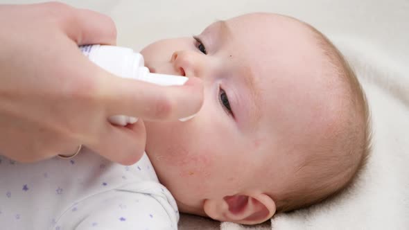 CLoseup of Applying Moisturizing Creme on Baby Skin Suffering From Dermatitis