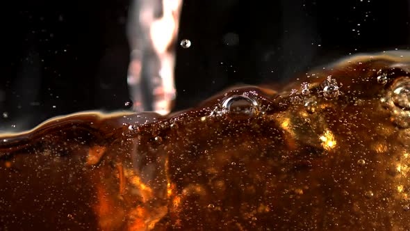 Pouring soft drink into glass, Slow Motion