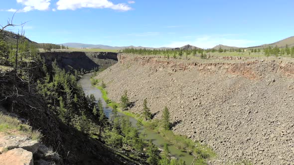 Broken Crumbled Rocks Spilling From the Narrow Canyon Slope Ridge Towards the Deep Valley Floor