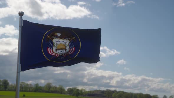 Utah Flag Waving in the Wind Blue Sky Background