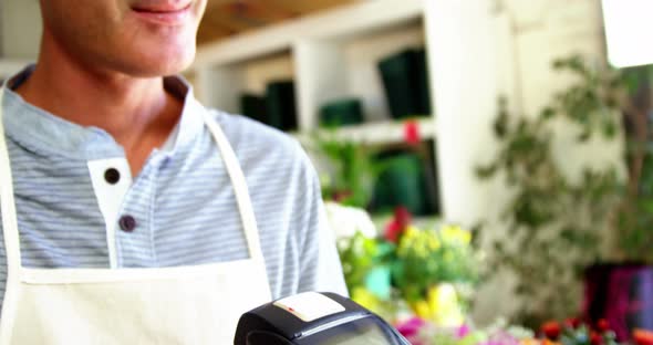 Customer making payment with credit card to florist