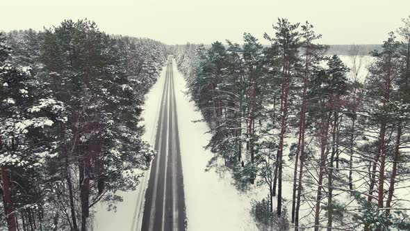 Fabulous Winter Landscape Aerial View Narrow Road in the Forest