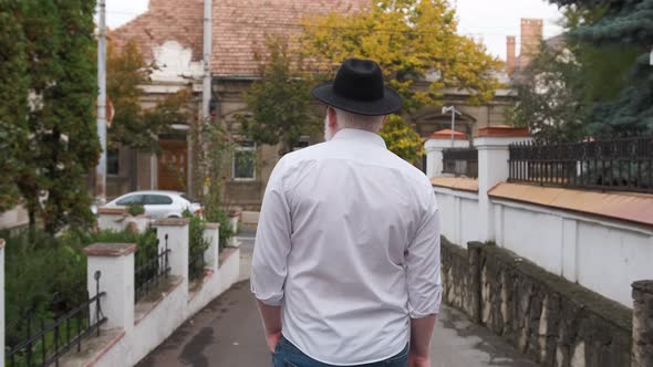 Caucasian Young Man with Albinism Is Walking Outside