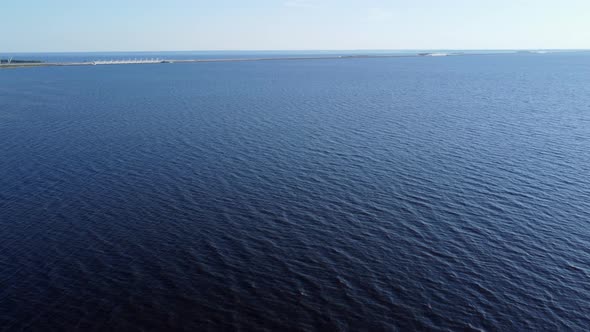 Flying Over Water and a Bridge in the Distance