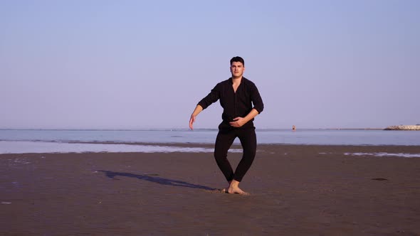 Guy in Black Performs Classic Ballet Dance on Empty Beach