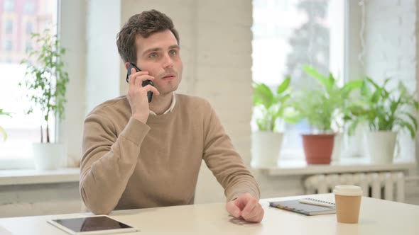 Man Talking on Smartphone in Office