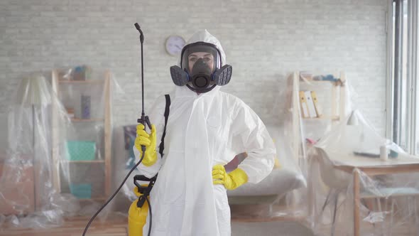 Portrait of a Young Woman Disinfector or Cleaning Company Looking Into the Camera