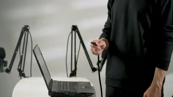 hand of man showing a usb cable plug