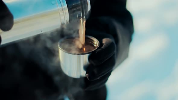 Hot Coffee From Thermos. Holiday Vacation Trip And Relaxing Moment. Woman Pouring Tea Into Cup.