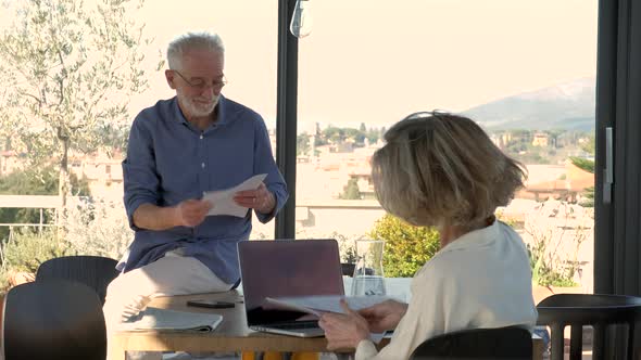 Senior couple doing paper work at home