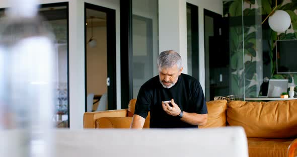 Male Executive Talking on Mobile Phone on Sofa 4k