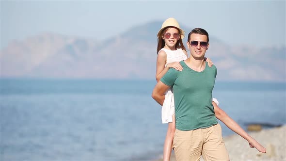 Little Girl and Happy Dad Having Fun During Beach Vacation