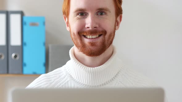 Man with Red Hairs Smiling at Work