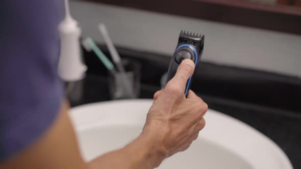 Closeup Shot of a Young Man That Shaves His Beard Using a Beard Trimmer