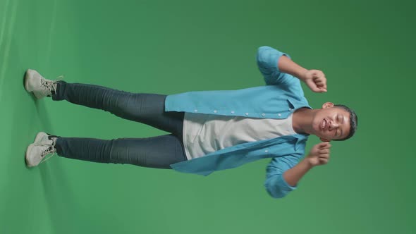 Full Body Of Young Asian Boy Dancing In A Green Screen Studio