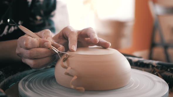 Potter, Craftsman is Working on Pottery Wheel, Rotating the Wheel Fast, Removes Extra Clay