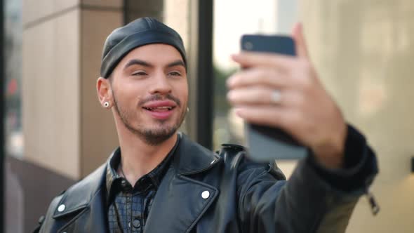 Joyful Handsome Gay Man Using Video Chat on Smartphone Standing on City Street Outdoors