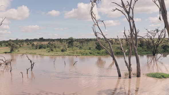 Waterhole lake in Laikipia, Kenya. Aerial drone backwards reveal of Kenyan landscape