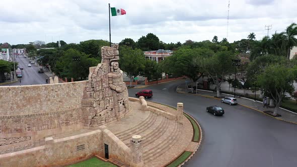 Aerial ascent and camera pitch down of the Monument a la Patria, Homeland Monument with Mexican flag