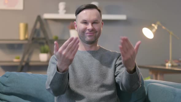 Portrait of Casual Man Pointing and Inviting